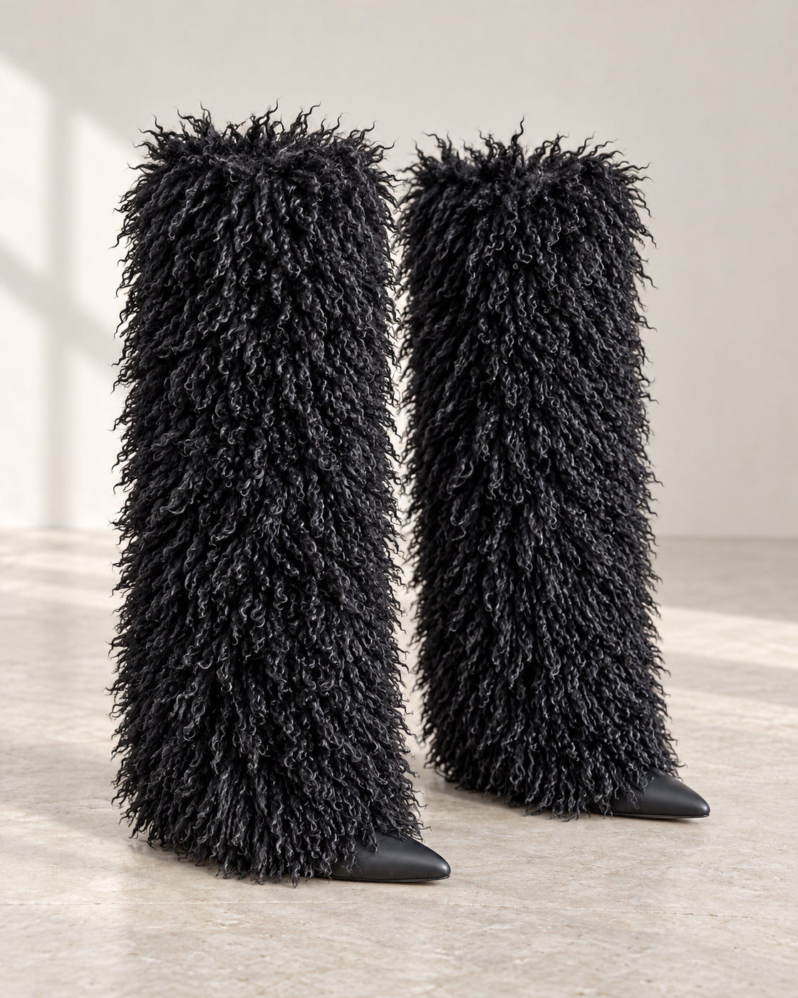 Borelle Shag Boots in Black — curled shag pair with smooth pointed toes