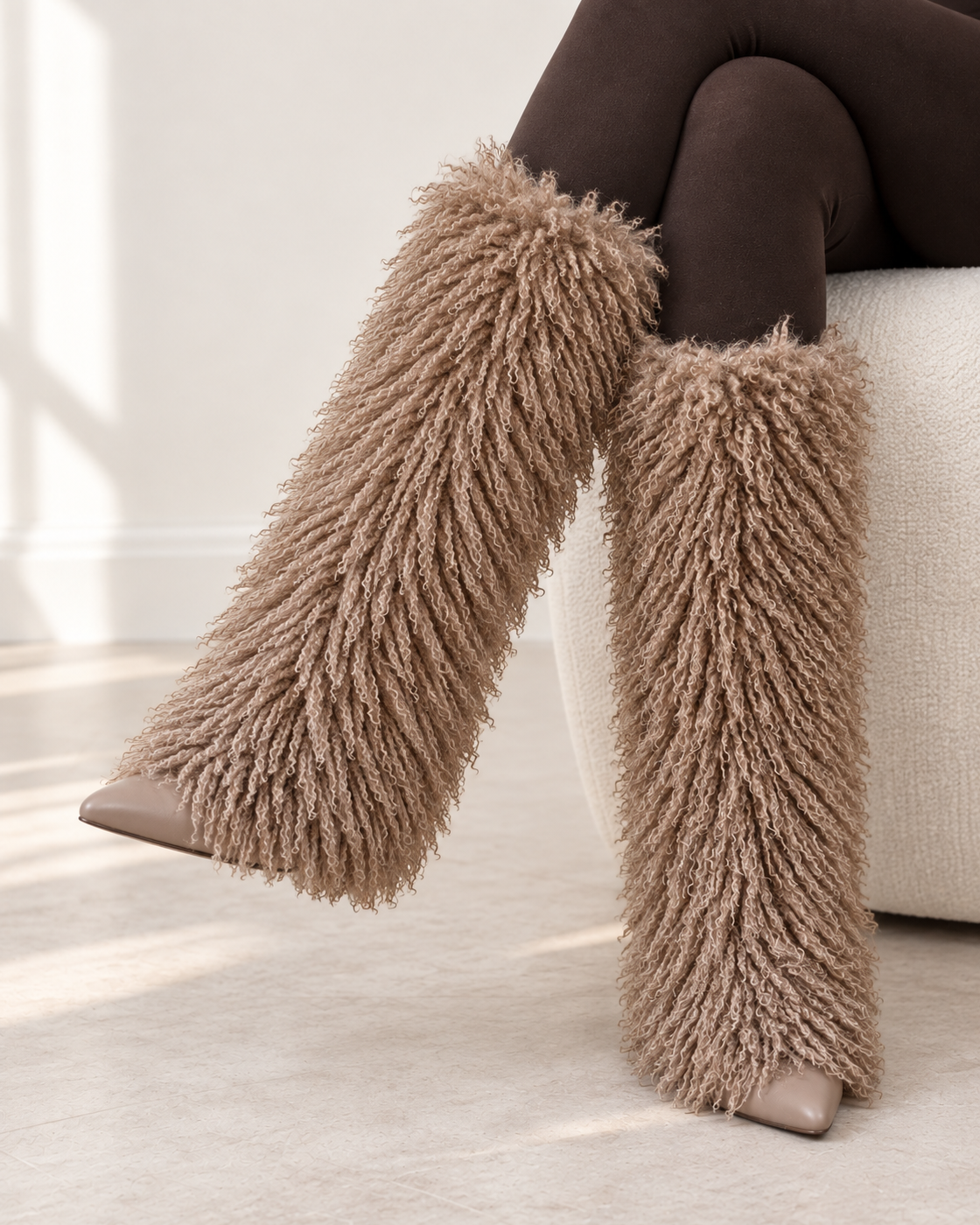 Borelle Shag Boots in Taupe — crossed raised on foot