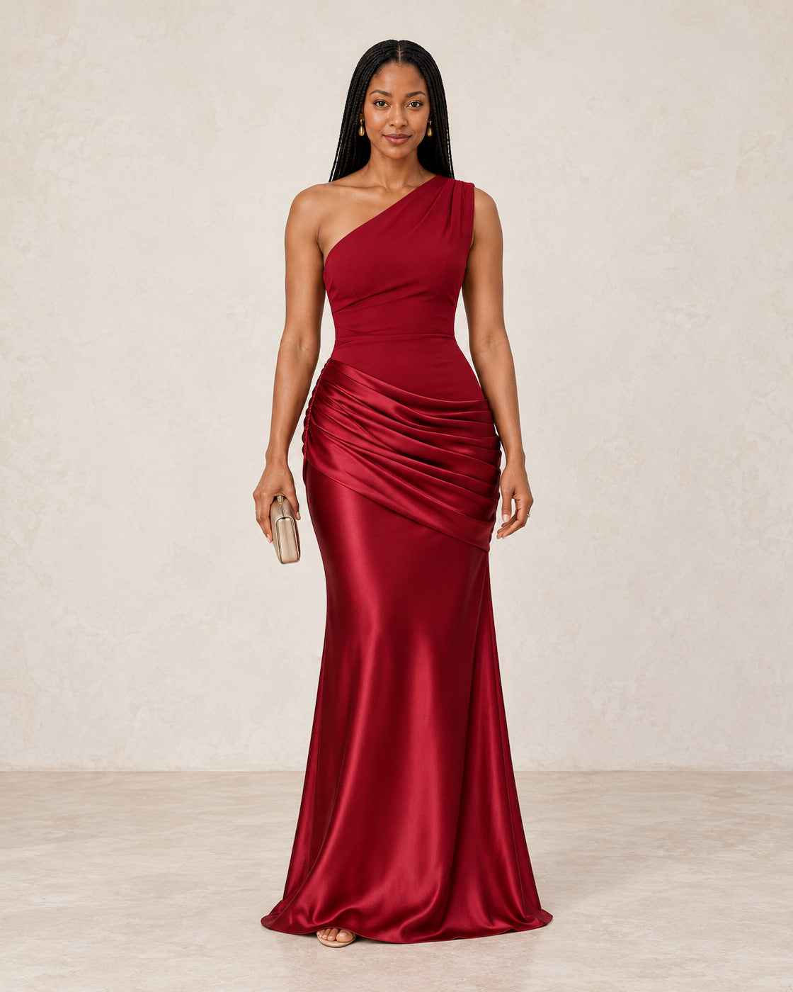 Front view of the Delphine Draped Gown in red, showing its one-shoulder neckline and draped skirt