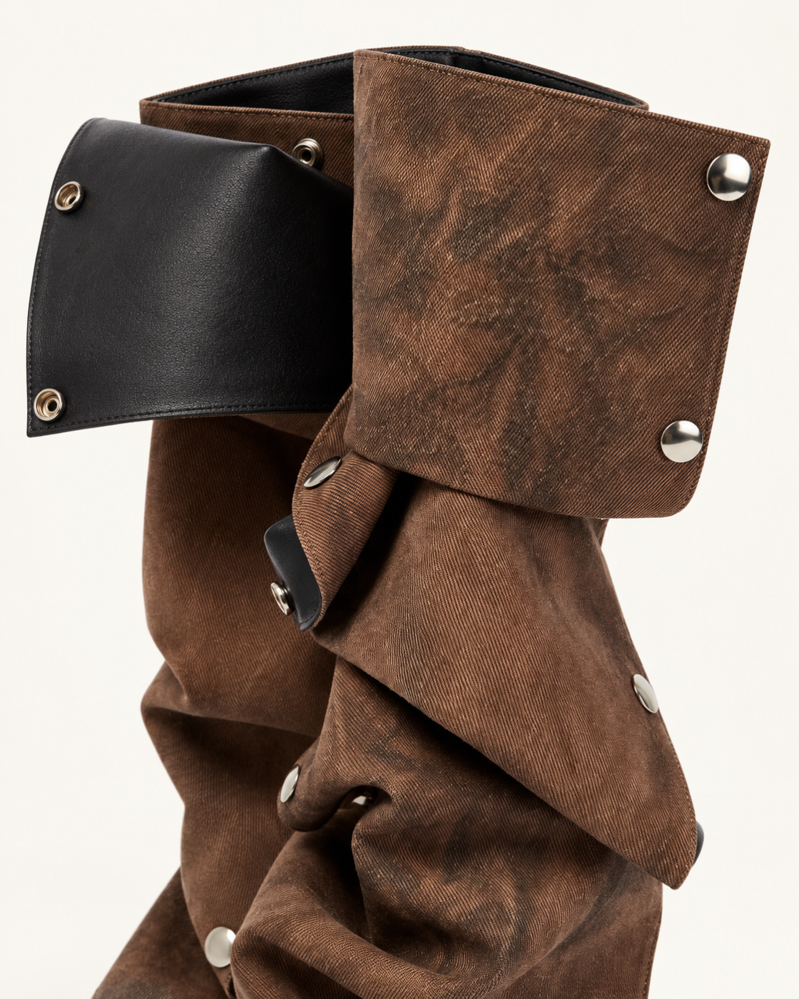 Close-up of the Brown removable cuff, black lining and silver-tone snap fasteners