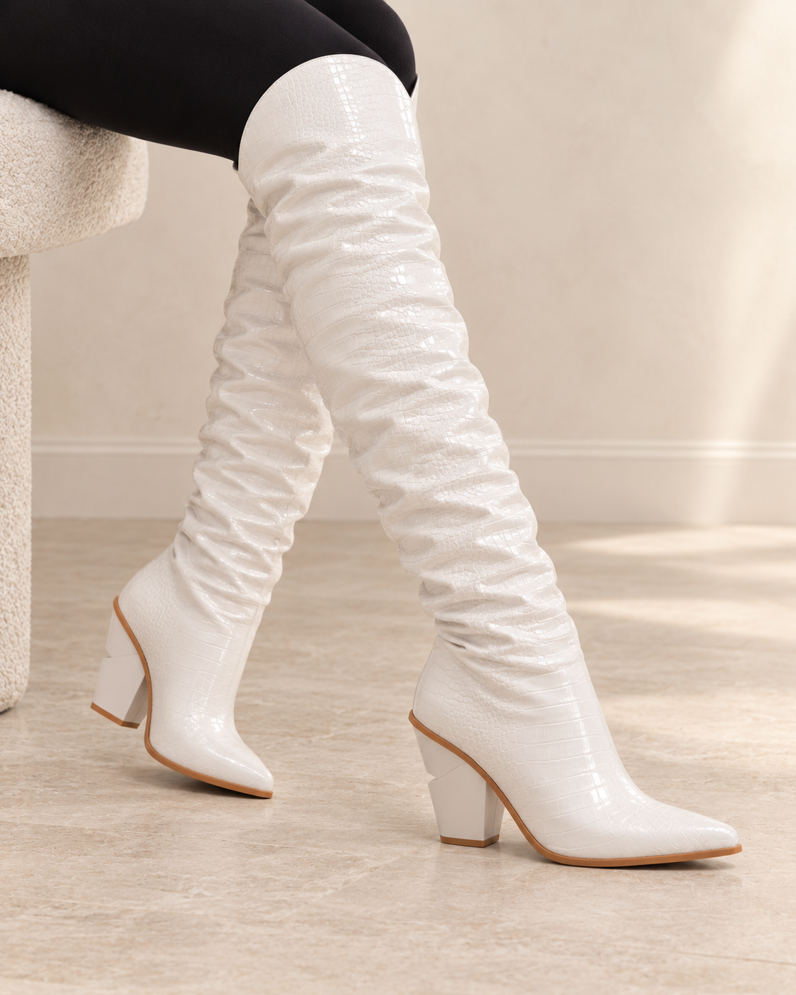 Oriana Western Boots in Bone — crossed raised on foot